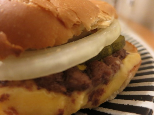 A blurry photograph of a regular cheeseburger.  It's tasty in focus or out.